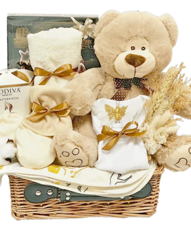 Neutral-colored baby hamper filled with luxurious gifts, organic cotton clothing, Belgian chocolate, and a soft toy