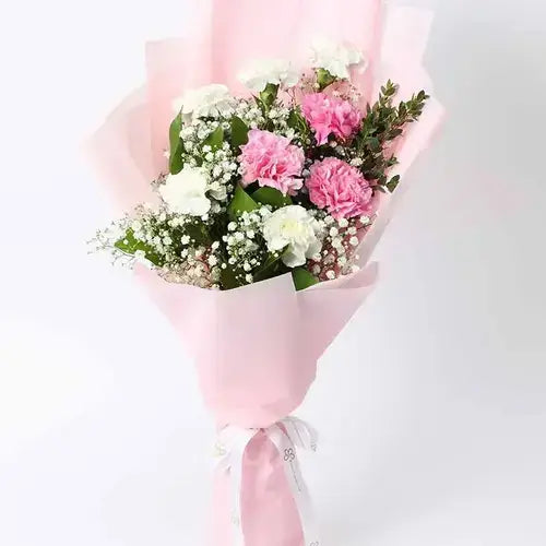 Elegant flower bouquet wrapped in pink with a white ribbon bow