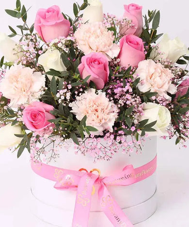 Enchanted Elegance: Pink & White Floral Basket": Showcase a beautifully arranged basket overflowing with 7 soft pink roses, 6 pristine white roses, and 4 delicate pink carnations.