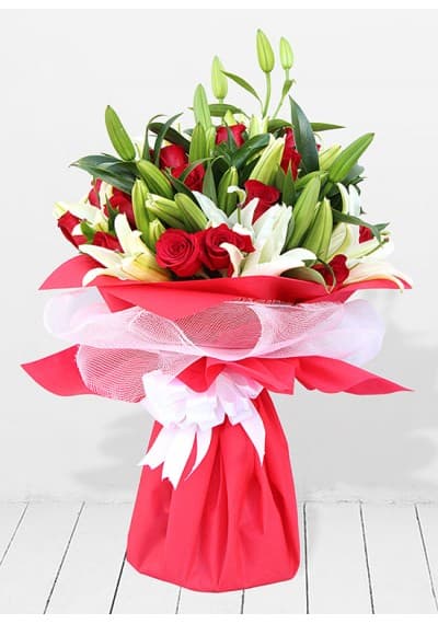 Breathtaking arrangement of 20 white lilies and 15 deep red roses, symbolizing purity and love.