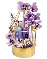 Beautiful gift set featuring lavender hand wash, diffuser, soap, artificial flowers, dried flowers, and gold metal decor basket.
