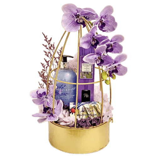 Beautiful gift set featuring lavender hand wash, diffuser, soap, artificial flowers, dried flowers, and gold metal decor basket.