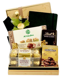 The Executive Gift Basket with chocolates, Arabian sweets, notebook, wrapped in cellophane with ribbons and bows.