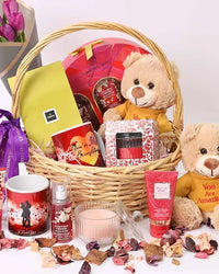 Beauty Desire Gift Basket with purple tulips, plush, chocolates, mug, candle, and Bath & Body Works set.