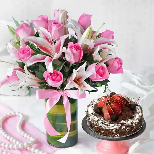 Roses and lilies bouquet with Black Forest cake – flower and cake gift delivery in Dubai, UAE