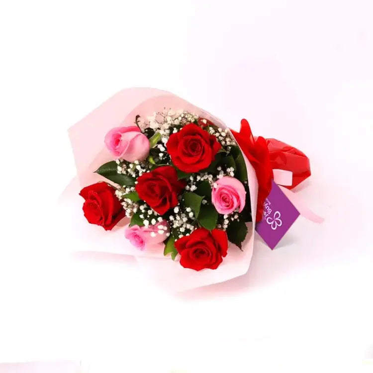 My Cutie Pie 7 Roses Bouquet with red and pink roses, wrapped in ribbon.