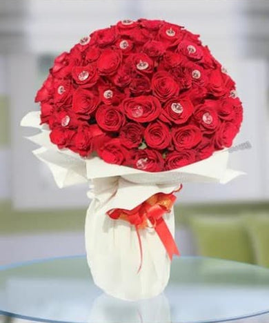 A hand-tied bouquet of 100 premium roses, ready to be delivered to a loved one in the UAE