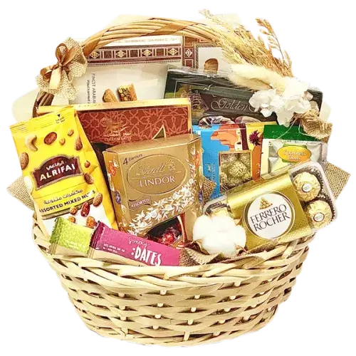 Photo of a beautiful handwoven market basket overflowing with a variety of Arabic sweets, chocolates, dates, and nuts, perfect for a gift