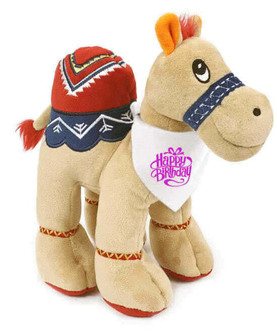 Adorable beige camel plush, 25cm tall, wearing a pink "Happy Birthday" bandana. Super soft and cuddly with recycled filling.