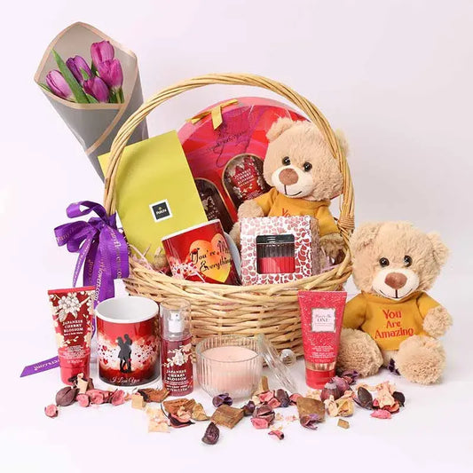 Beauty Desire Gift Basket with purple tulips, plush, chocolates, mug, candle, and Bath & Body Works set.