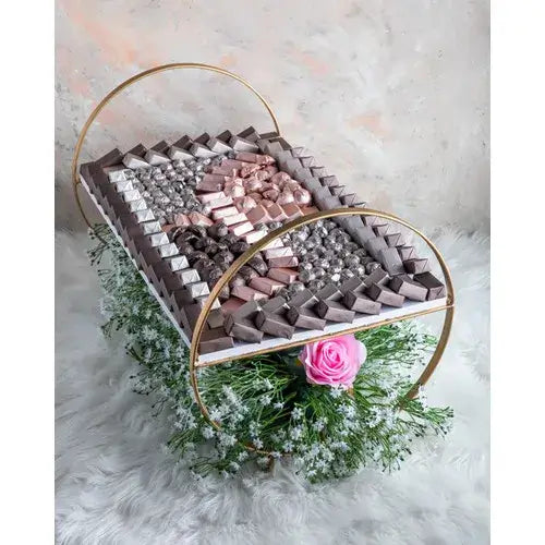  Large chocolate tray with assorted chocolates and faux flowers (Chocolate Gift Baskets Dubai - giftshop.ae).