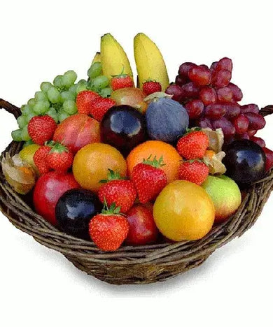 A photo of a large wicker gift basket overflowing with a colorful assortment of fresh seasonal fruits.