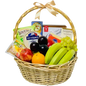 A photo of a wicker gift basket overflowing with colorful fruits, gourmet cheese wedges, a chocolate bar, and various crackers.