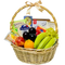 A photo of a wicker gift basket overflowing with colorful fruits, gourmet cheese wedges, a chocolate bar, and various crackers.