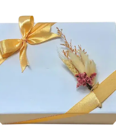 a beautifully wrapped Self-Care Escape for Her gift set with Lindt chocolates, hand cream, a scented candle, and a white flap box with a bow