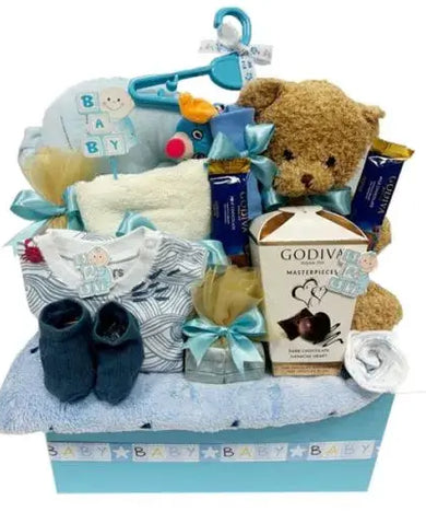 Pink or blue baby gift basket with blanket, bonnet, hanger, pillow, socks, towel, teether, soft toy, romper suit, chocolates.