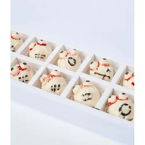  Photo of a box filled with Halloween-themed mini cake pops decorated like zombies