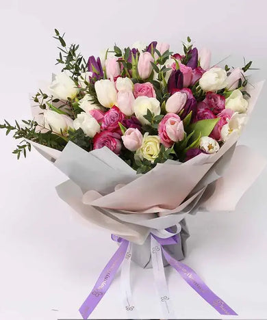 Grand rose and tulip bouquet with mixed colors (white, pink, purple) and Ferrero Rocher chocolates.