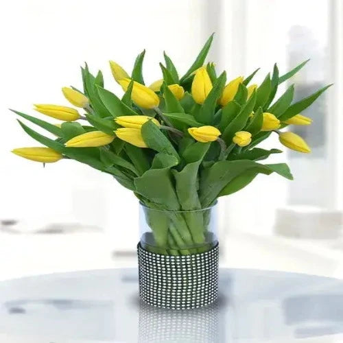 A vibrant bouquet of yellow tulips arranged in a clear vase. Perfect gift to brighten someone's day. Delivered fresh across Dubai and the UAE.