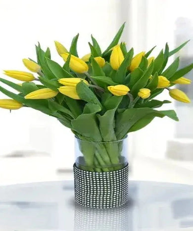 A vibrant bouquet of yellow tulips arranged in a clear vase. Perfect gift to brighten someone's day. Delivered fresh across Dubai and the UAE.