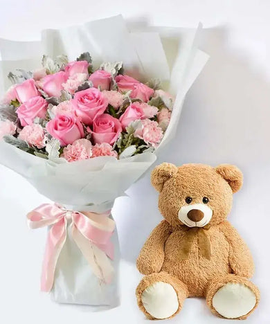 Person receiving the bouquet and teddy bear, expressing delight and hugging the teddy bear.