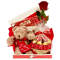 Photo of a romantic gift set featuring a red rose, a box of Belgian chocolates, and a soft teddy bear, perfect for expressing love