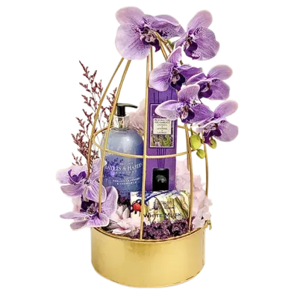  a beautifully arranged Baylis & Harding Lavender Spa Gift Basket with hand wash, reed diffuser, soap, artificial/dried flowers, and a gold metal flower decor basket