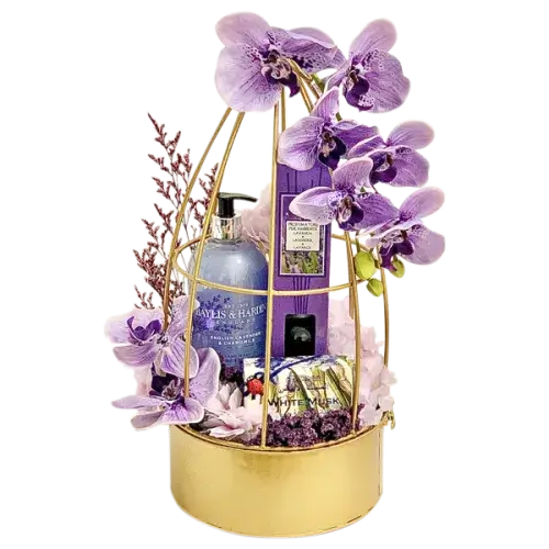  a beautifully arranged Baylis & Harding Lavender Spa Gift Basket with hand wash, reed diffuser, soap, artificial/dried flowers, and a gold metal flower decor basket