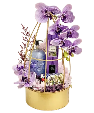  a beautifully arranged Baylis & Harding Lavender Spa Gift Basket with hand wash, reed diffuser, soap, artificial/dried flowers, and a gold metal flower decor basket