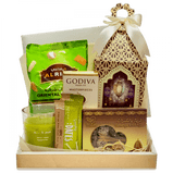 Celebrate Ramadan Delights" Gift Box: Cellophane-wrapped box with a decorative Ramadan lantern on top, overflowing with dates, chocolates, snacks, and a scented candle.