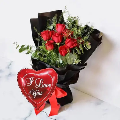 Express your love with a bang! Red roses, "I love you" balloon & black gift wrap, delivered fresh across UAE.