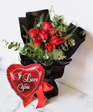 Express your love with a bang! Red roses, "I love you" balloon & black gift wrap, delivered fresh across UAE.