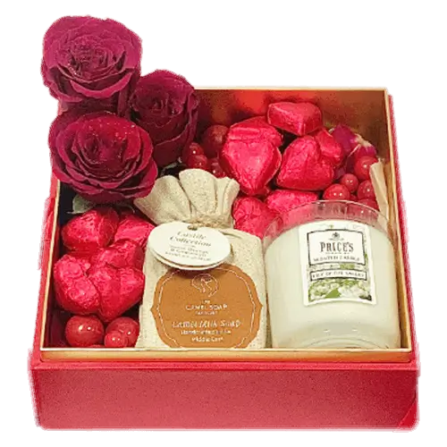 Luxury gift box with red roses, camel milk soap, chocolates, and a candle. Tied with ribbons in an acrylic box (Romantic Gift Dubai).