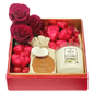 Luxury gift box with red roses, camel milk soap, chocolates, and a candle. Tied with ribbons in an acrylic box (Romantic Gift Dubai).