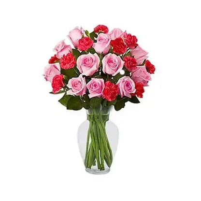 Clear vase with red and pink roses and carnations.