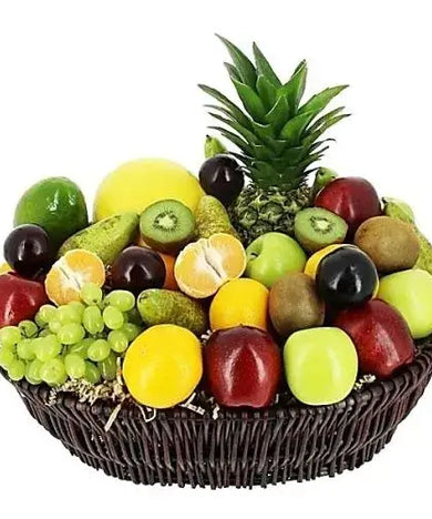 A photo of a large wicker basket overflowing with a colorful assortment of seasonal and exotic fruits, including avocado, longan, Asian pears, persimmons, and satsumas