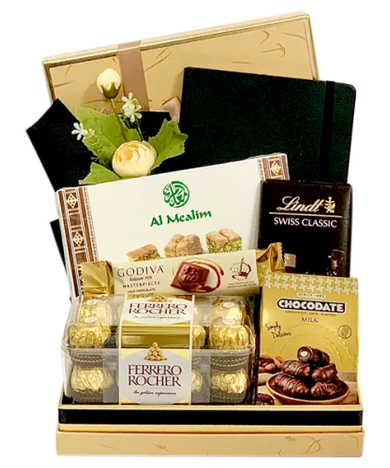 The Executive Gift Basket with chocolates, Arabian sweets, notebook, wrapped in cellophane with ribbons and bows.