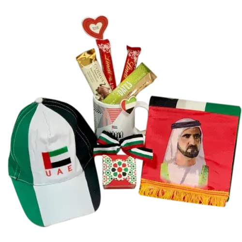 Gift bag with UAE National Day colors containing chocolates, mug, cap, and scarf (UAE National Day Hamper Dubai - giftshop.ae)