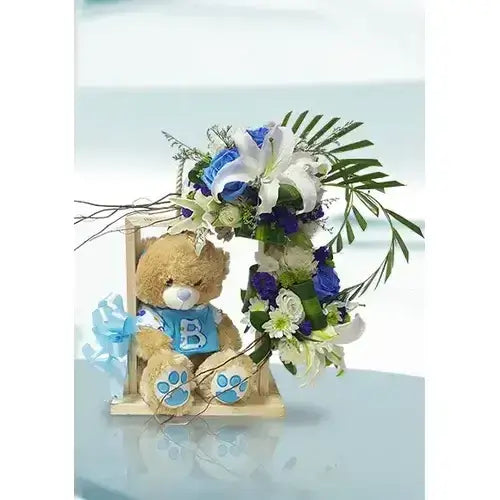 Photo of a gift basket with blue & white flowers and a teddy bear