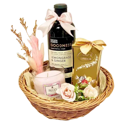  a beautifully presented Women's Day Gift Hamper filled with chocolates, bath essentials, a candle, and a decorative round basket