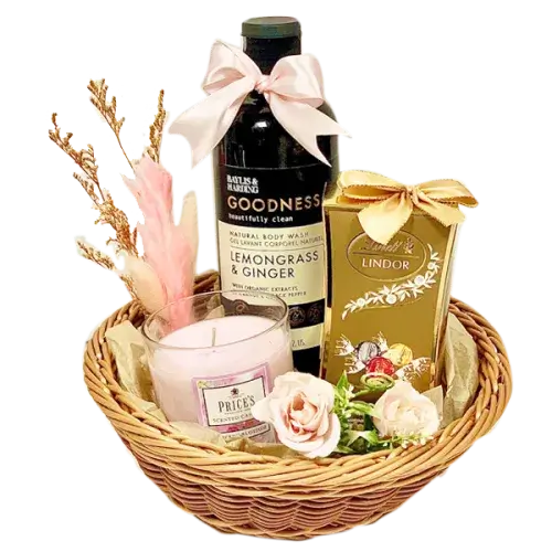  a beautifully presented Women's Day Gift Hamper filled with chocolates, bath essentials, a candle, and a decorative round basket