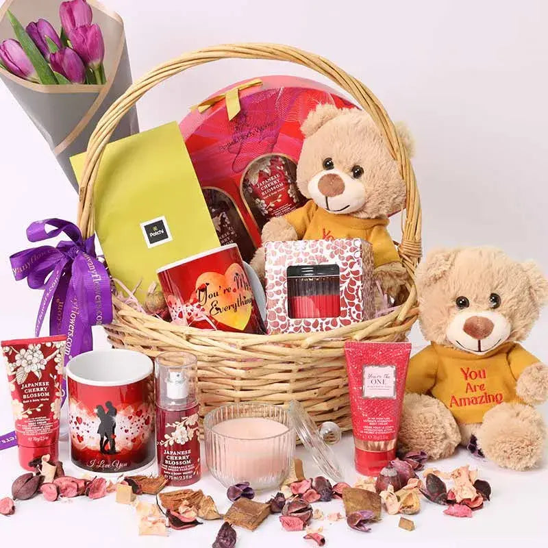 Beauty Desire Gift Basket with purple tulips, plush, chocolates, mug, candle, and Bath & Body Works set.