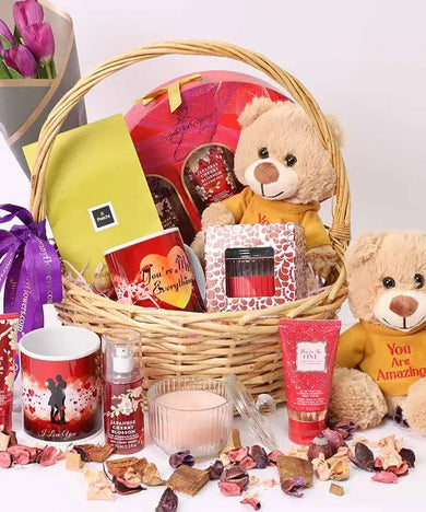 Beauty Desire Gift Basket with purple tulips, plush, chocolates, mug, candle, and Bath & Body Works set.