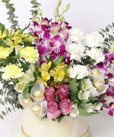  Vibrant flower arrangement with orchids, carnations, roses & Ferrero Rocher (Dubai delivery). Perfect gift!