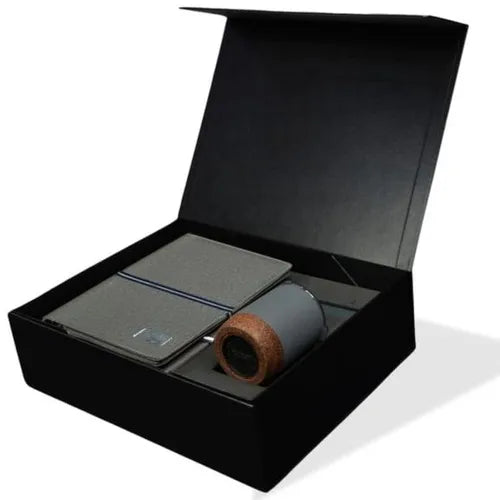 Black gift box containing a notebook organizer with power bank, magnetic phone mount, and insulated cork mug.