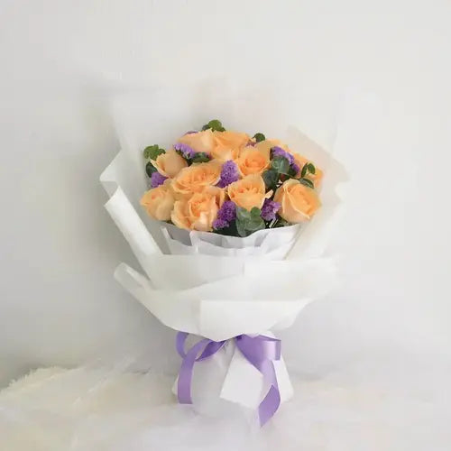 Flashing peach rose bouquet with purple statice for delivery in Dubai, UAE