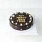 Happy New Year chocolate cake with assorted truffles, perfect for gifting in celebration.