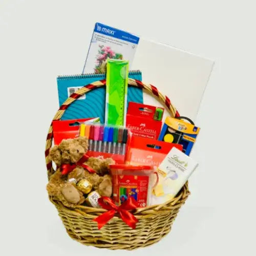 Kids art gift set in a wicker basket with Faber-Castell colors, sketch pad, and teddy.