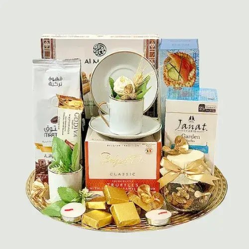 Luxury tea and coffee hamper on a gold round tray with chocolates, sweets, and premium coffee.