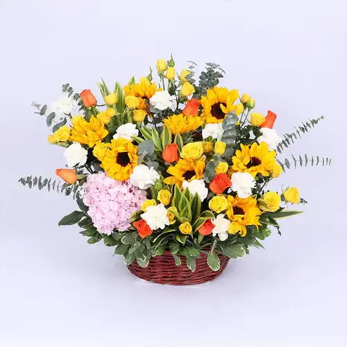 Sunflower and rose flower basket with handle, filled with greenery. Dubai flower delivery (UAE)